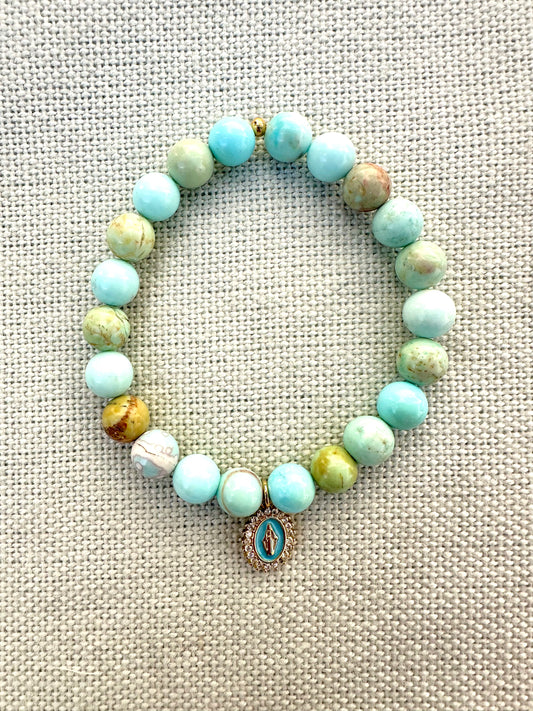 Blue swirl beach bracelet adorned with delicate blue enamel Virgin Mary Charm