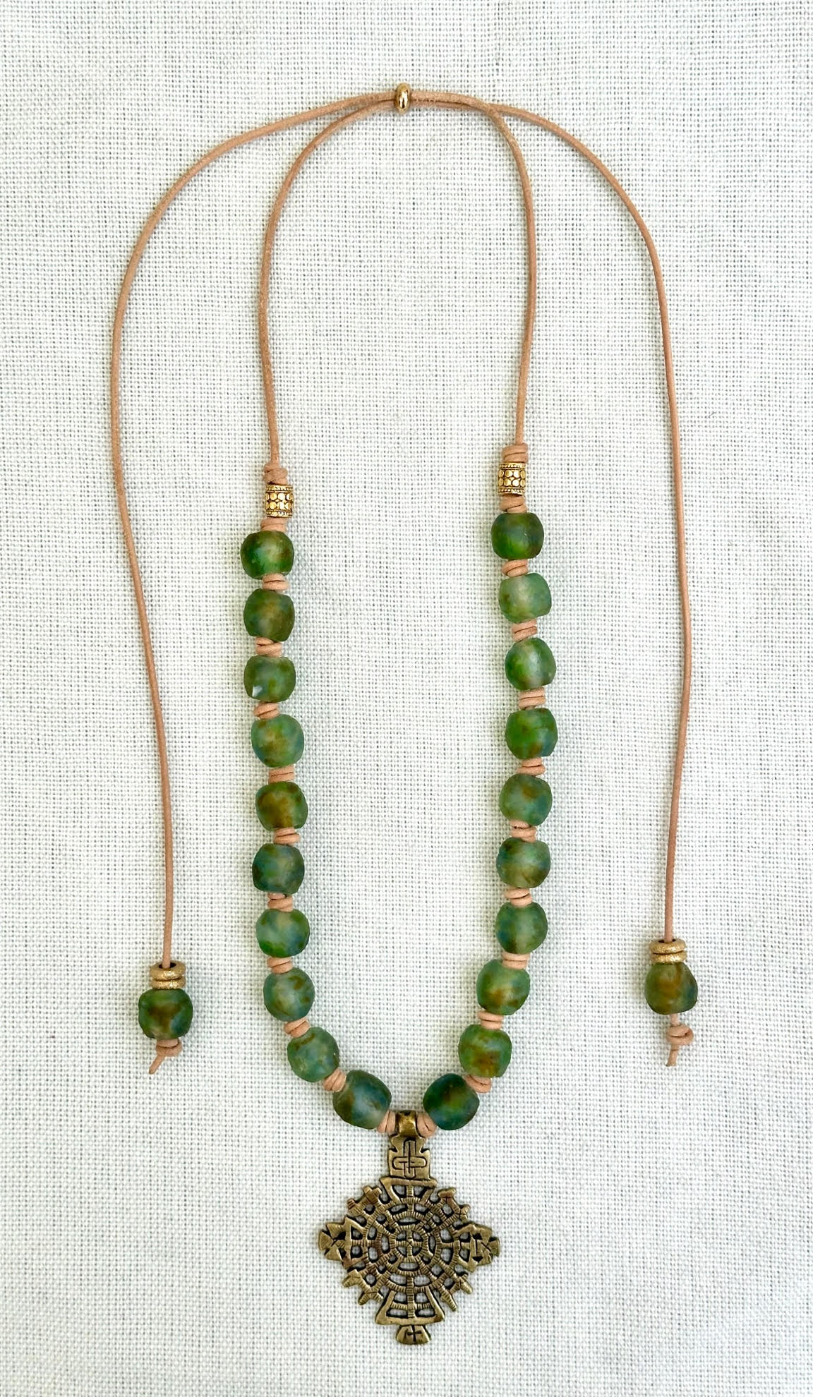 Variegated Blue, Green, Brown Glass Beaded Necklace with Ethiopian Brass Cross Pendant